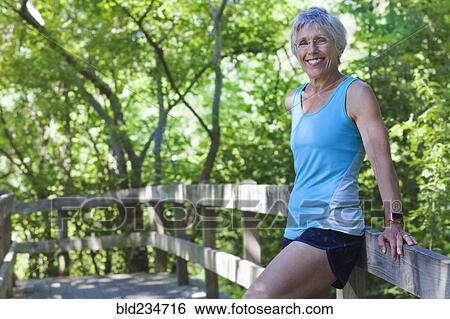 Caucasian woman leaning on wooden fence View Large Photo Image Stock Photograph - Caucasian woman leaning on wooden fence. Fotosearch