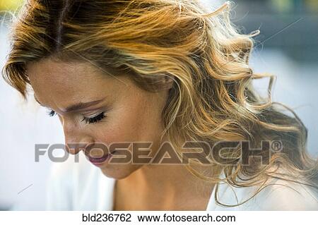 Stock Image - Caucasian woman looking down. Fotosearch