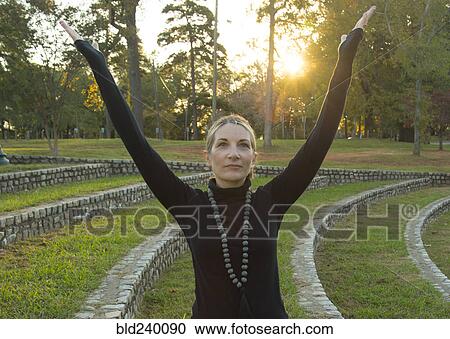 Caucasian woman meditating in park View Large Photo Image Stock Image - Caucasian woman meditating in park. Fotosearch