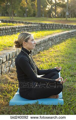 Caucasian woman meditating in park View Large Photo Image Stock Image - Caucasian woman meditating in park. Fotosearch