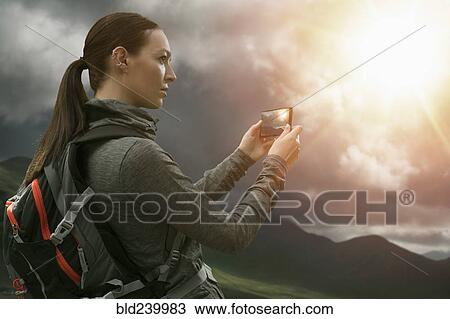 Caucasian woman photographing mountain landscape with cell phone View Large Photo Image Stock Image - Caucasian woman photographing mountain landscape with cell phone. Fotosearch