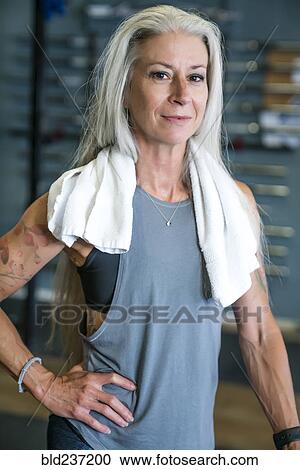 Caucasian woman posing in gymnasium wearing towel View Large Photo Image Stock Image - Caucasian woman posing in gymnasium wearing towel. Fotosearch
