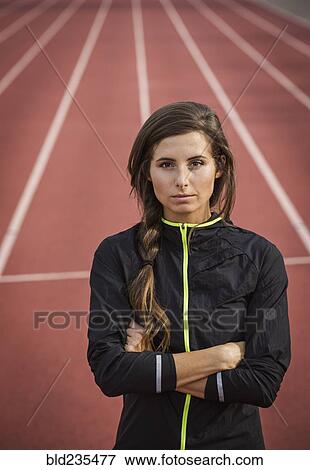 Caucasian woman posing on running track View Large Photo Image Stock Photo - Caucasian woman posing on running track. Fotosearch