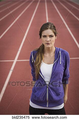 Caucasian woman posing on running track View Large Photo Image Stock Photography - Caucasian woman posing on running track. Fotosearch