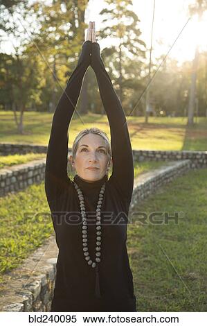 Caucasian woman practicing yoga in park View Large Photo Image Stock Photography - Caucasian woman practicing yoga in park. Fotosearch