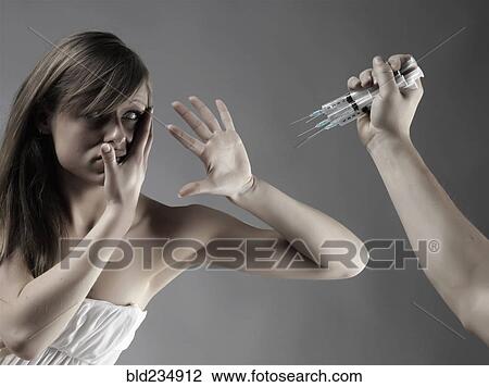 Caucasian woman protecting face from syringes View Large Photo Image Stock Image - Caucasian woman protecting face from syringes. Fotosearch