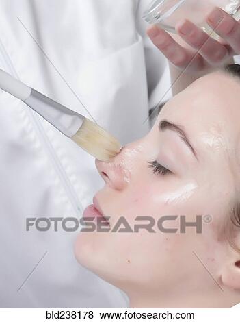 Stock Photo - Caucasian woman receiving facial beauty treatment. Fotosearch