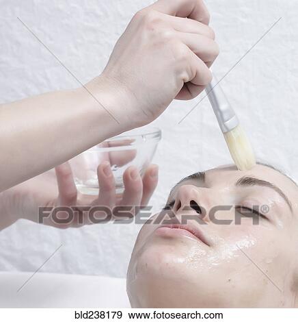 Stock Photo - Caucasian woman receiving facial beauty treatment. Fotosearch