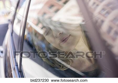 Caucasian woman relaxing in car View Large Photo Image Stock Image - Caucasian woman relaxing in car. Fotosearch