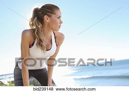 Stock Photo - Caucasian woman resting at beach. Fotosearch