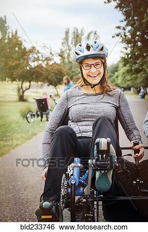 Stock Photograph - Caucasian woman riding tandem bicycle. Fotosearch
