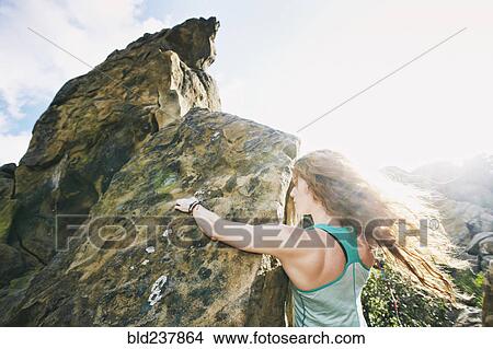Picture - Caucasian woman rock climbing. Fotosearch
