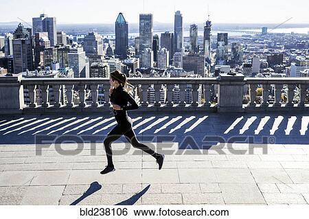 Stock Photograph - Caucasian woman running in city. Fotosearch