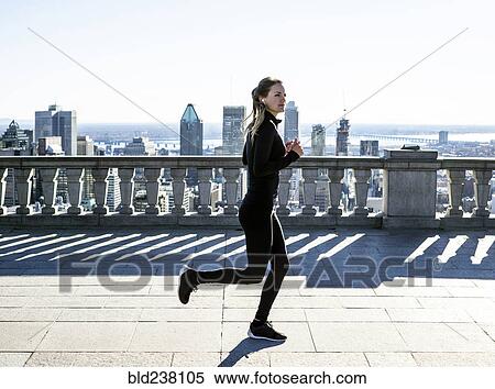 Caucasian woman running in city View Large Photo Image Stock Photography - Caucasian woman running in city. Fotosearch