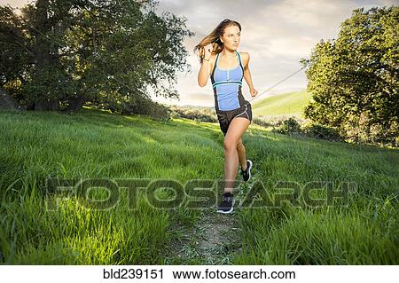Caucasian woman running on hill View Large Photo Image Stock Image - Caucasian woman running on hill. Fotosearch