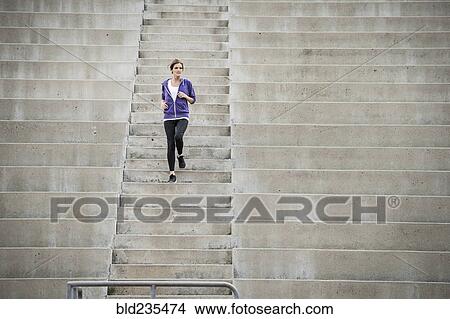 Caucasian woman running on stadium staircase View Large Photo Image Picture - Caucasian woman running on stadium staircase. Fotosearch