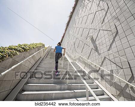 Caucasian woman running on staircase View Large Photo Image Stock Image - Caucasian woman running on staircase. Fotosearch