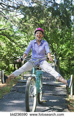 Caucasian woman sitting on bicycle with legs apart View Large Photo Image Stock Image - Caucasian woman sitting on bicycle with legs apart. Fotosearch