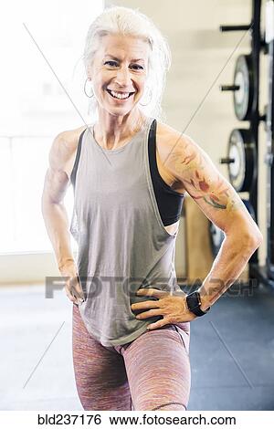 Caucasian woman smiling in gymnasium View Large Photo Image Stock Photograph - Caucasian woman smiling in gymnasium. Fotosearch