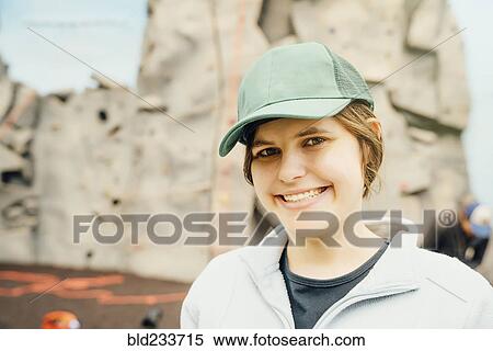 Caucasian woman smiling near rock climbing wall View Large Photo Image Stock Photography - Caucasian woman smiling near rock climbing wall. Fotosearch