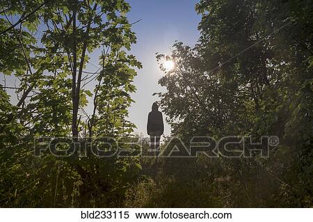 Stock Photography - Caucasian woman standing in forest. Fotosearch