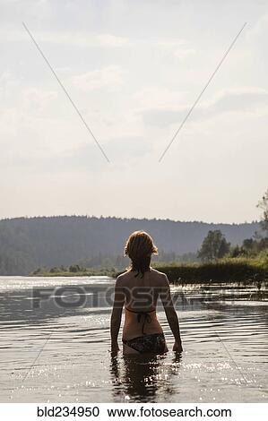 Caucasian woman standing in lake wearing bikini View Large Photo Image Stock Image - Caucasian woman standing in lake wearing bikini. Fotosearch