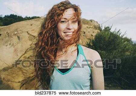 Caucasian woman standing near boulder in wind View Large Photo Image Stock Photography - Caucasian woman standing near boulder in wind. Fotosearch