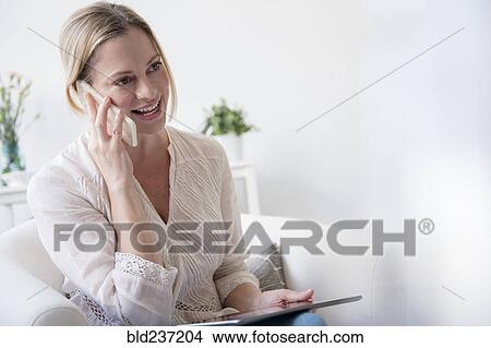 Picture - Caucasian woman talking on cell phone. Fotosearch