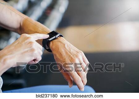 Caucasian woman tapping smart watch View Large Photo Image Stock Image - Caucasian woman tapping smart watch. Fotosearch