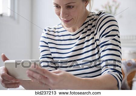 Caucasian woman texting on cell phone View Large Photo Image Stock Image - Caucasian woman texting on cell phone. Fotosearch