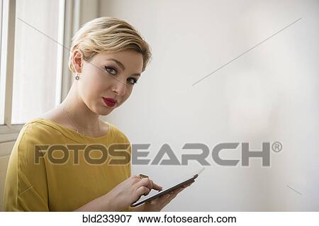 Caucasian woman using digital tablet View Large Photo Image Stock Photo - Caucasian woman using digital tablet. Fotosearch