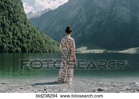 Caucasian woman wading in mountain lake View Large Photo Image Picture - Caucasian woman wading in mountain lake. Fotosearch