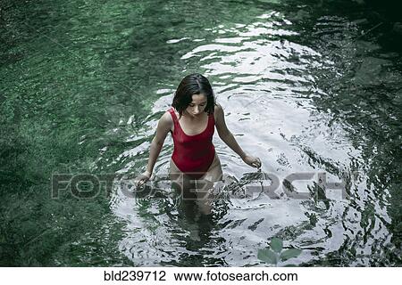 Caucasian woman wading in pool of water View Large Photo Image Stock Image - Caucasian woman wading in pool of water. Fotosearch