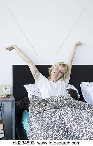 Caucasian woman waking in bed View Large Photo Image Stock Image - Caucasian woman waking in bed. Fotosearch