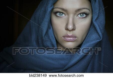 Stock Photo - Caucasian woman wearing blue headscarf. Fotosearch