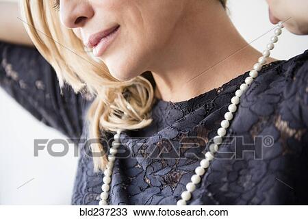 Caucasian woman wearing pearl necklace View Large Photo Image Stock Image - Caucasian woman wearing pearl necklace. Fotosearch