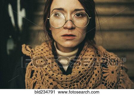 Stock Image - Caucasian woman wearing scarf and eyeglasses. Fotosearch