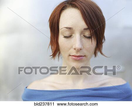 Stock Image - Caucasian woman with eyes closed. Fotosearch