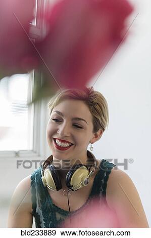 Caucasian woman with headphones around neck View Large Photo Image Stock Photo - Caucasian woman with headphones around neck. Fotosearch