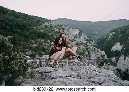 Caucasian women hugging on mountain View Large Photo Image Stock Image - Caucasian women hugging on mountain. Fotosearch