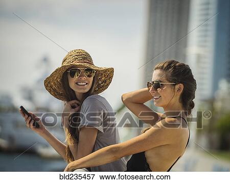 Stock Photo - Caucasian women leaning on railing. Fotosearch