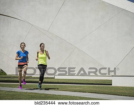 Caucasian women running near architecture View Large Photo Image Picture - Caucasian women running near architecture. Fotosearch
