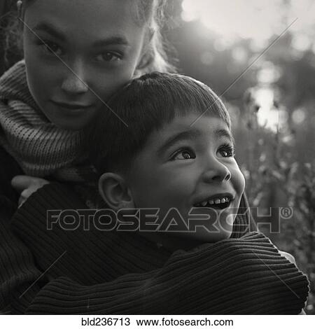 Caucasian women wearing sweater hugging boy View Large Photo Image Stock Image - Caucasian women wearing sweater hugging boy. Fotosearch