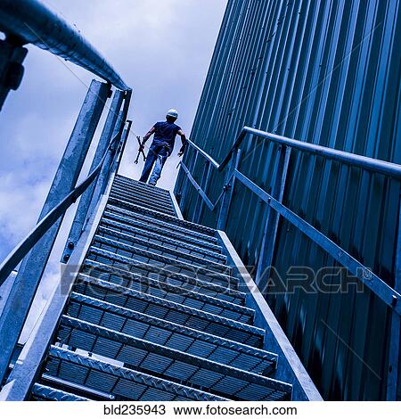 Caucasian worker carrying tools on staircase View Large Photo Image Stock Image - Caucasian worker carrying tools on staircase. Fotosearch