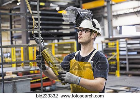 Caucasian worker holding controller in factory View Large Photo Image Stock Image - Caucasian worker holding controller in factory. Fotosearch