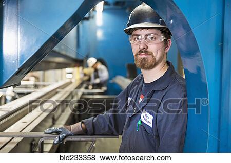 Caucasian worker posing in factory View Large Photo Image Stock Photo - Caucasian worker posing in factory. Fotosearch