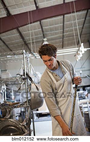Caucasian worker sweeping floor in bakery View Large Photo Image Stock Image - Caucasian worker sweeping floor in bakery. Fotosearch