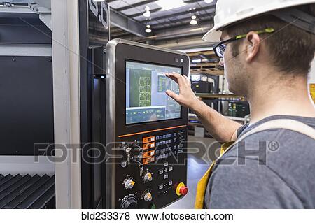Caucasian worker using control panel in factory View Large Photo Image Stock Photo - Caucasian worker using control panel in factory. Fotosearch