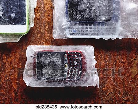 Stock Photography - Cell phones frozen in ice. Fotosearch