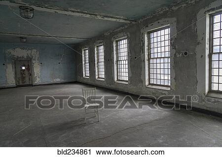 Stock Image - Chair in empty warehouse. Fotosearch
